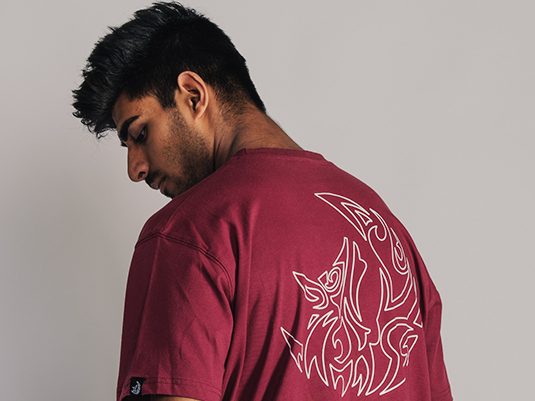 Danial wearing an Essential T-Shirt in the Color Maroon of our own collection